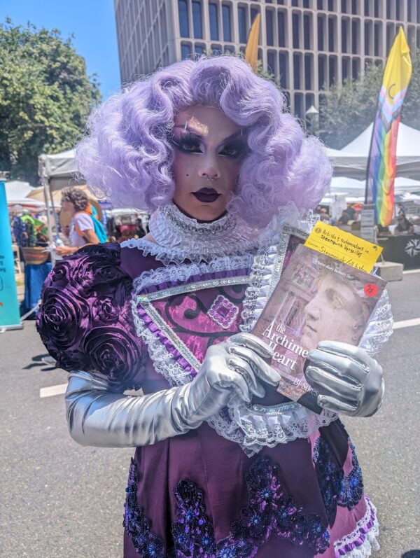 Drag queen holding a book